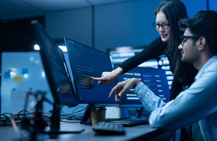 Profissionais em ambiente corporativo analisam dashboards e soluções de tecnologia corporativa, com foco em inteligência artificial, automação e transformação digital no Brasil.
